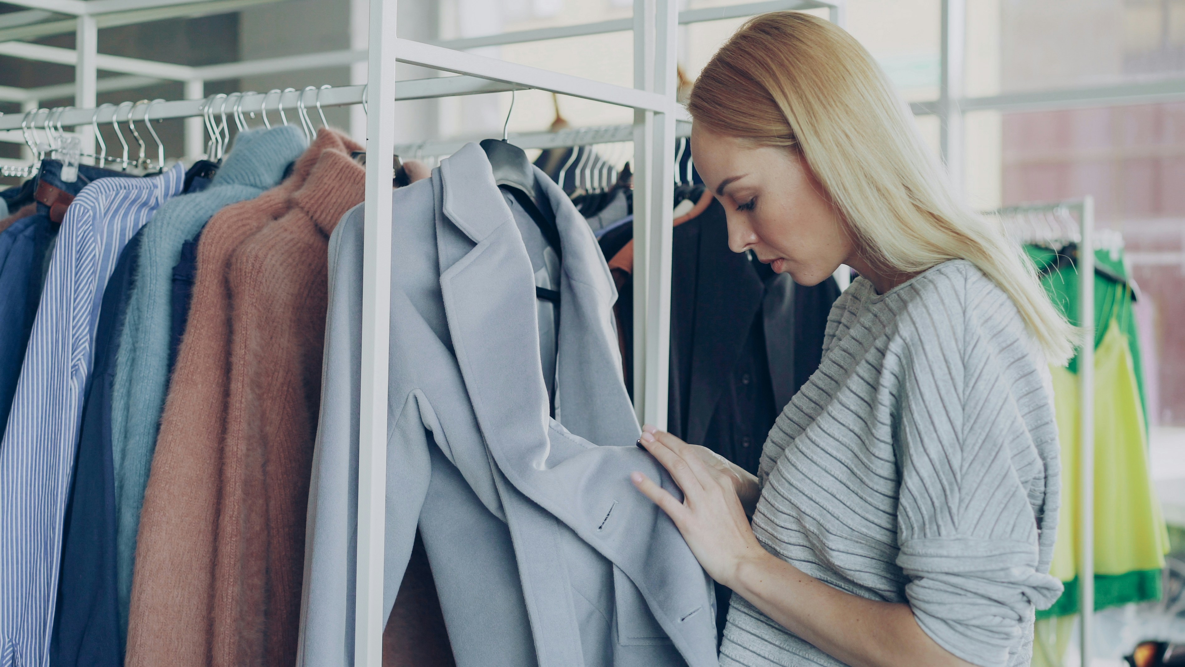 Inspector checking the stitching and finish of a wool coat